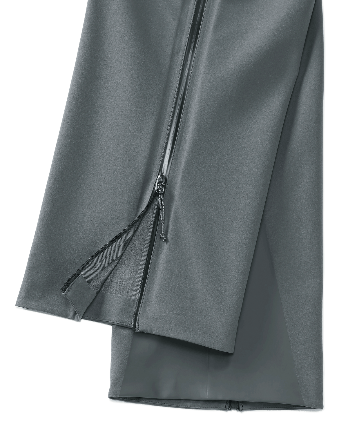 Lower, Side View of Women's Chugach TR Rain Pants in Gunmetal Grey Color Highlighting Full Length YKK Leg Zipper and Bemis Overlay Film Scuff Guards