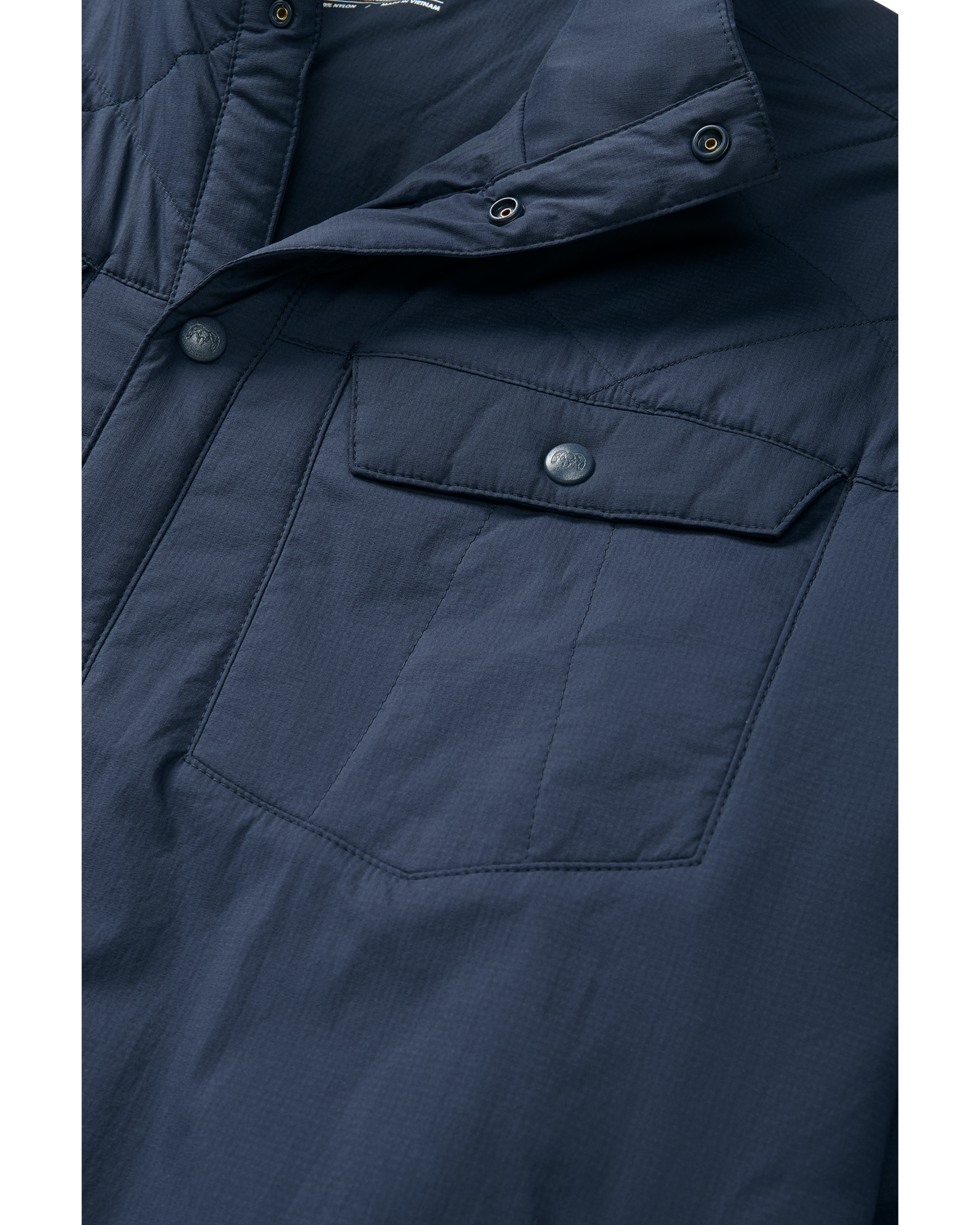 Detail image showing the chest pocket snap on the Base Camp Insulated Snap Shirt in Steel blue