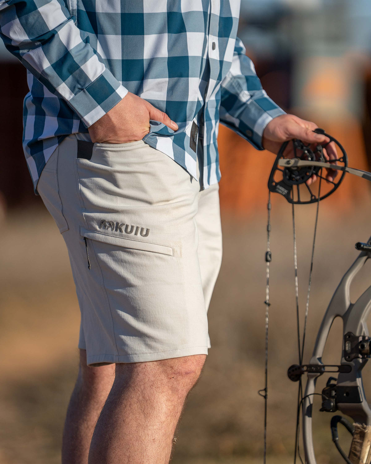 Close-up of hunter wearing Switchback Short in Lunar Grey with right hand in his pocket