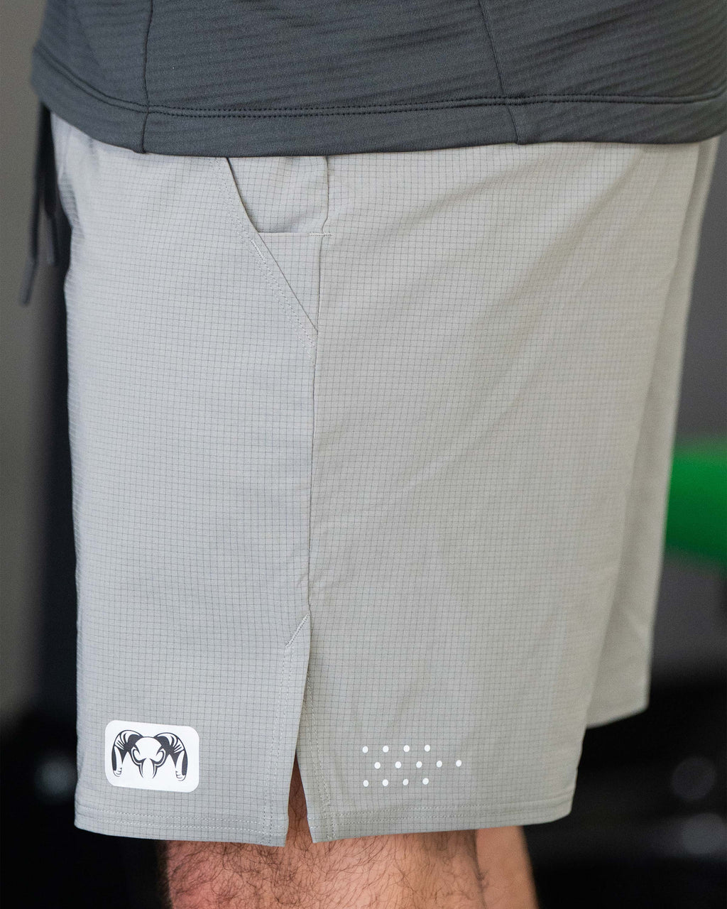 Side view of EnduroTrainer 7" Short in Shadow Grey, showing KUIU Ram reflective patch on bottom left leg hem 