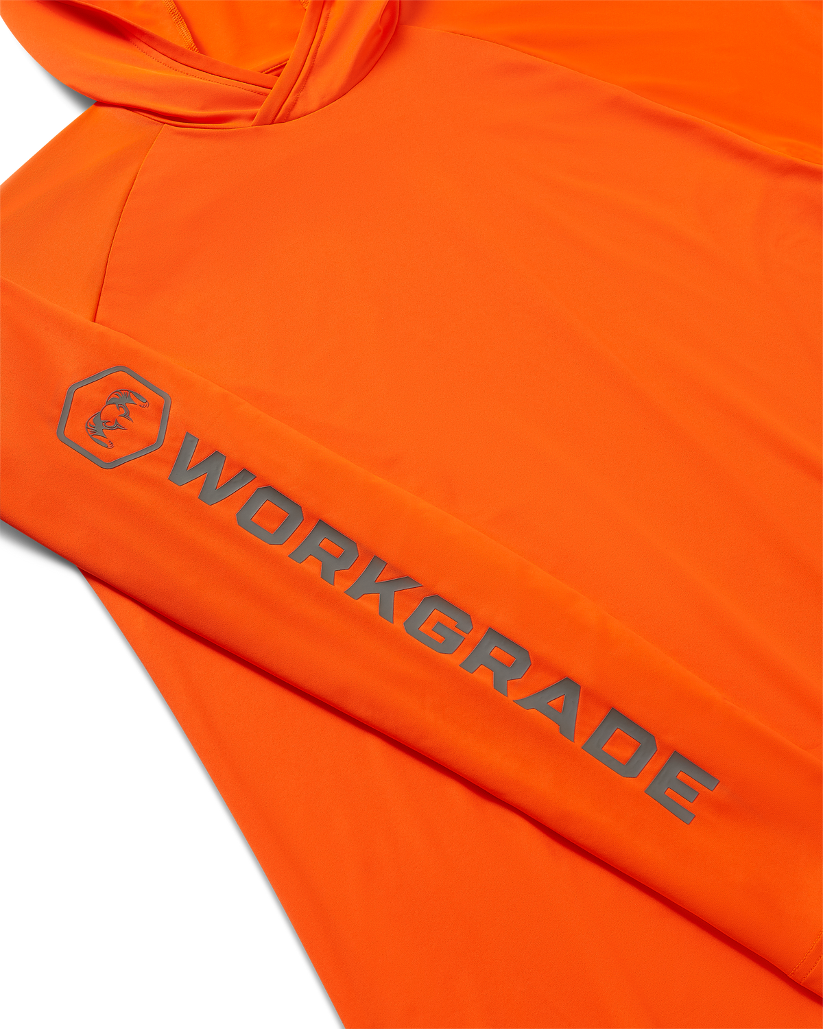 Close-up, flat lay of a Workgrade Long Sleeve Sun Hoodie in Blaze Orange laid flat, highlighting the sleeve with a bold “WORKGRADE” logo and hex emblem of a ram printed along the arm.
