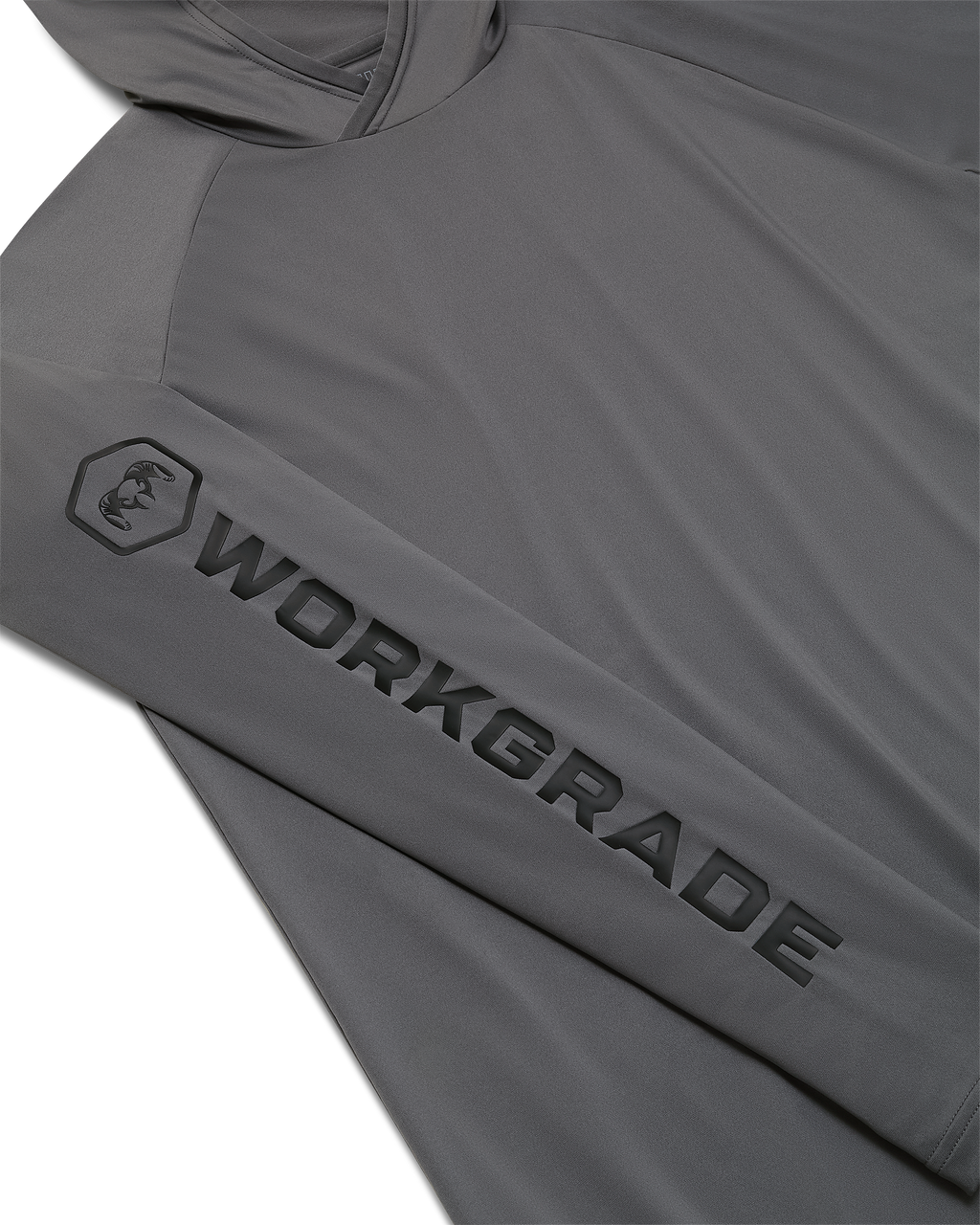 Close-up, flat lay of a Workgrade Long Sleeve Sun Hoodie in Castle Rock Grey laid flat, highlighting the sleeve with a bold “WORKGRADE” logo and hex emblem of a ram printed along the arm.