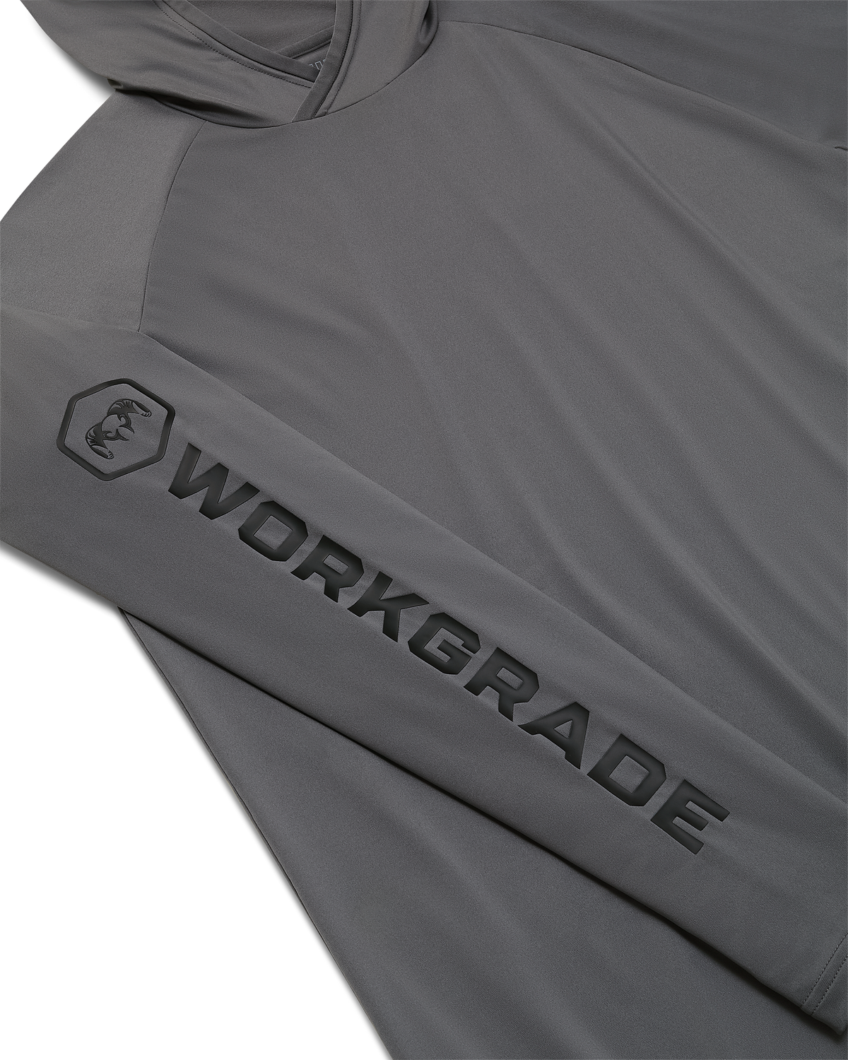 Close-up, flat lay of a Workgrade Long Sleeve Sun Hoodie in Castle Rock Grey laid flat, highlighting the sleeve with a bold “WORKGRADE” logo and hex emblem of a ram printed along the arm.