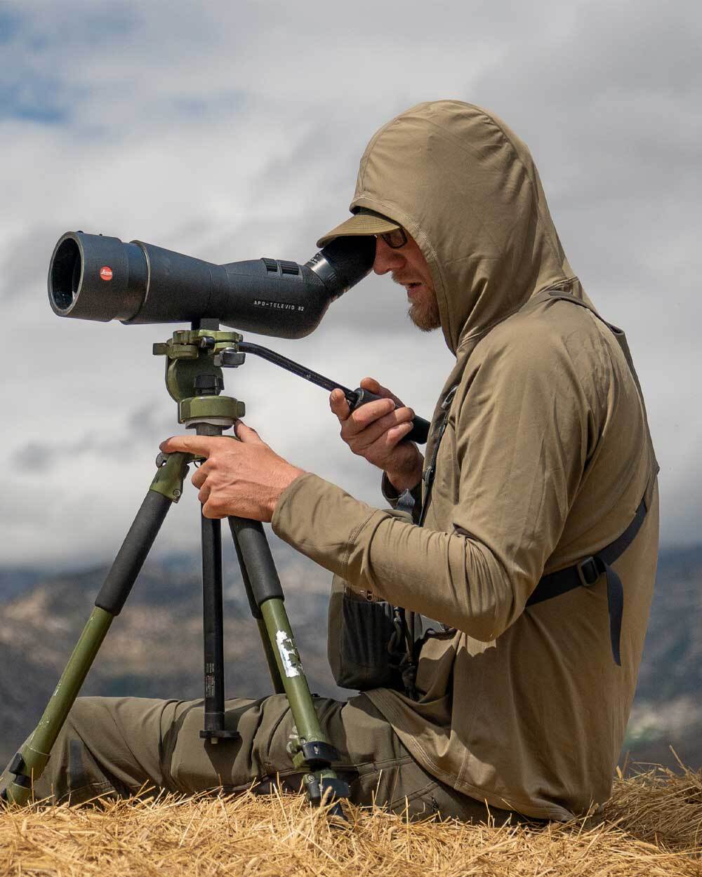 Hunter wearing Gila Long Sleeve Hoodie in Khaki, Glassing and Using a Spotting Scope