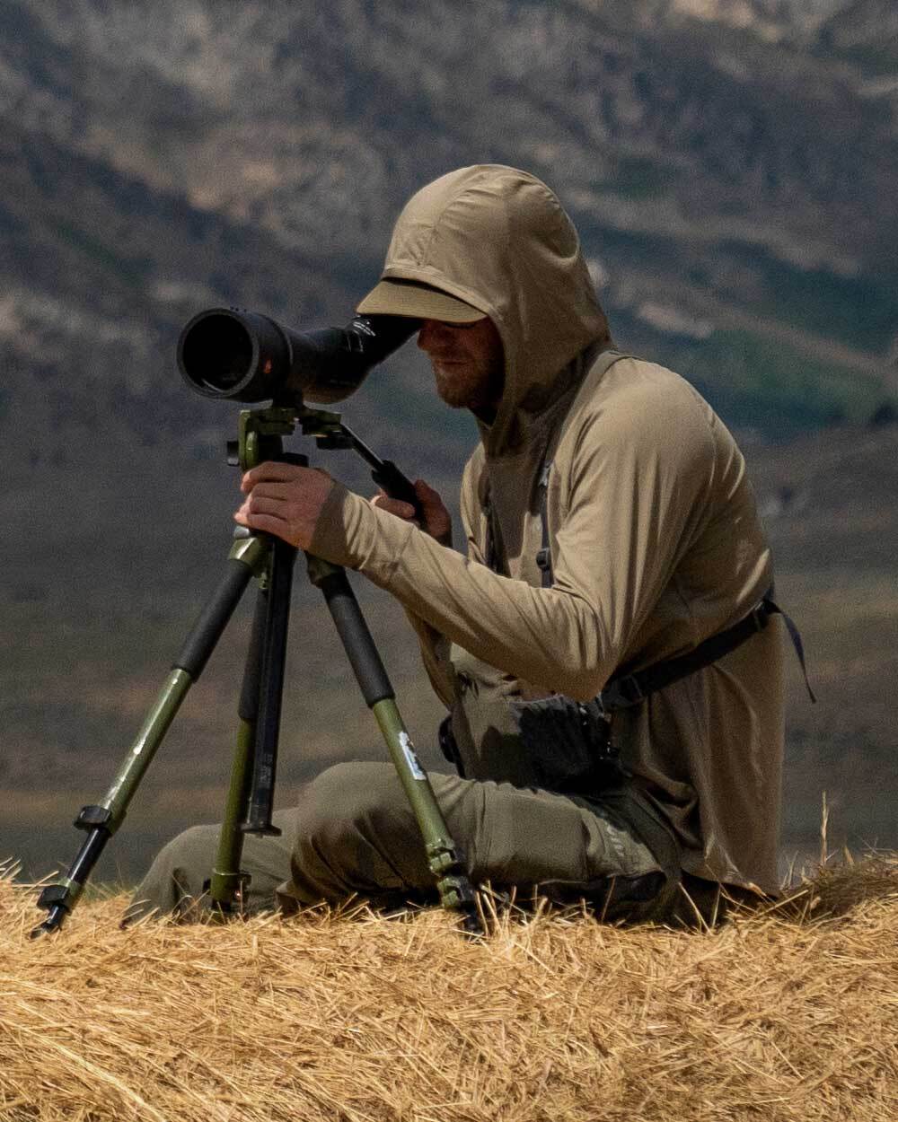 Hunter wearing Gila Long Sleeve Hoodie in Khaki, Glassing and Using a Spotting Scope