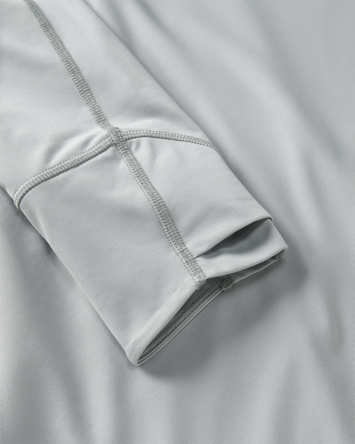 Close-up detail of layered  thumbhole on Gila LS Hoodie in Lunar Grey