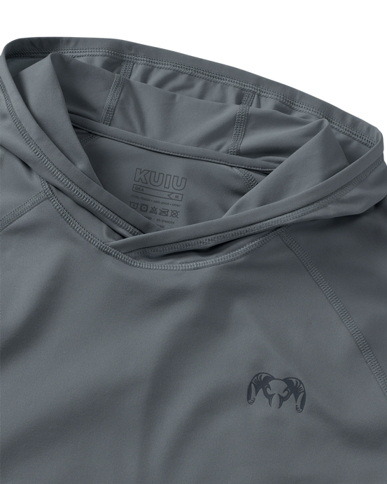 Close-up flat lay view of flatlock seams, folded hood, and KUIU Ram logo on left chest of Gila Long Sleeve Hoodie in Slate Grey