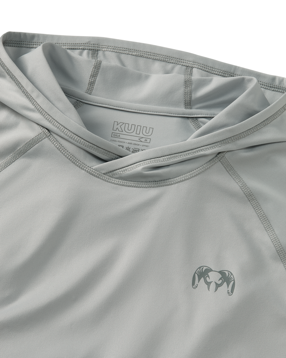 Close-up flat lay view of flatlock seams, folded hood, and KUIU Ram logo on left chest of Gila Long Sleeve Hoodie in Talus Grey