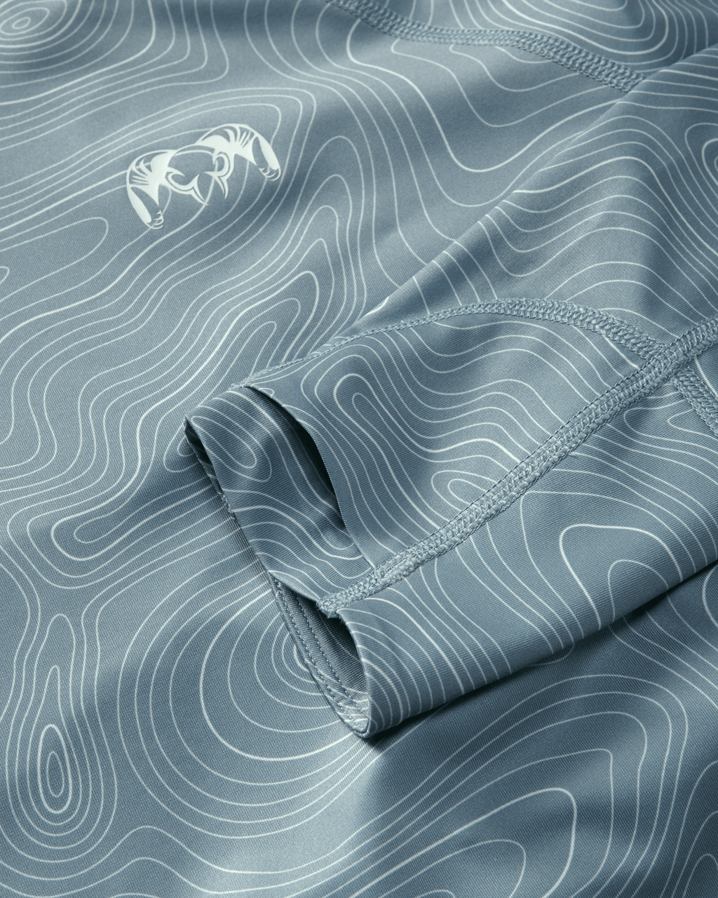 Flat highly breathable fabric and layer thumbhole on Gila LS Hoodie in Glacier Blue Topo Print