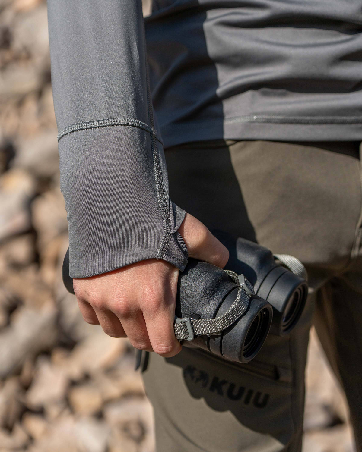 Close-up of layered thumbholes on the Youth Gila Long Sleeve Hoodie in Stone Grey