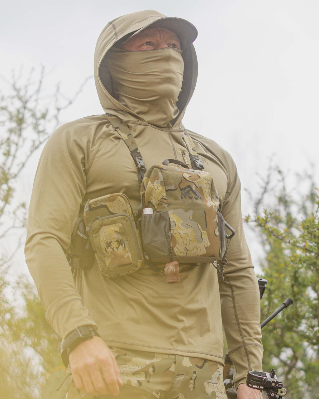 Hunter wearing Gila PRO LS Hoodie in Khaki using hood and built-in neck gaiter