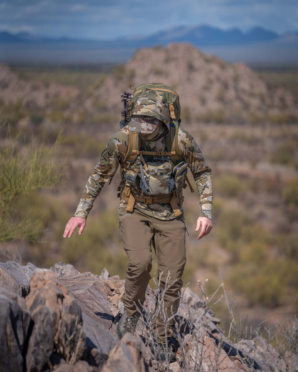 Hunter Hiking Up Rocky Hill in Mexico in Gila Pro Long Sleeve Hoodie in Valo Camouflage