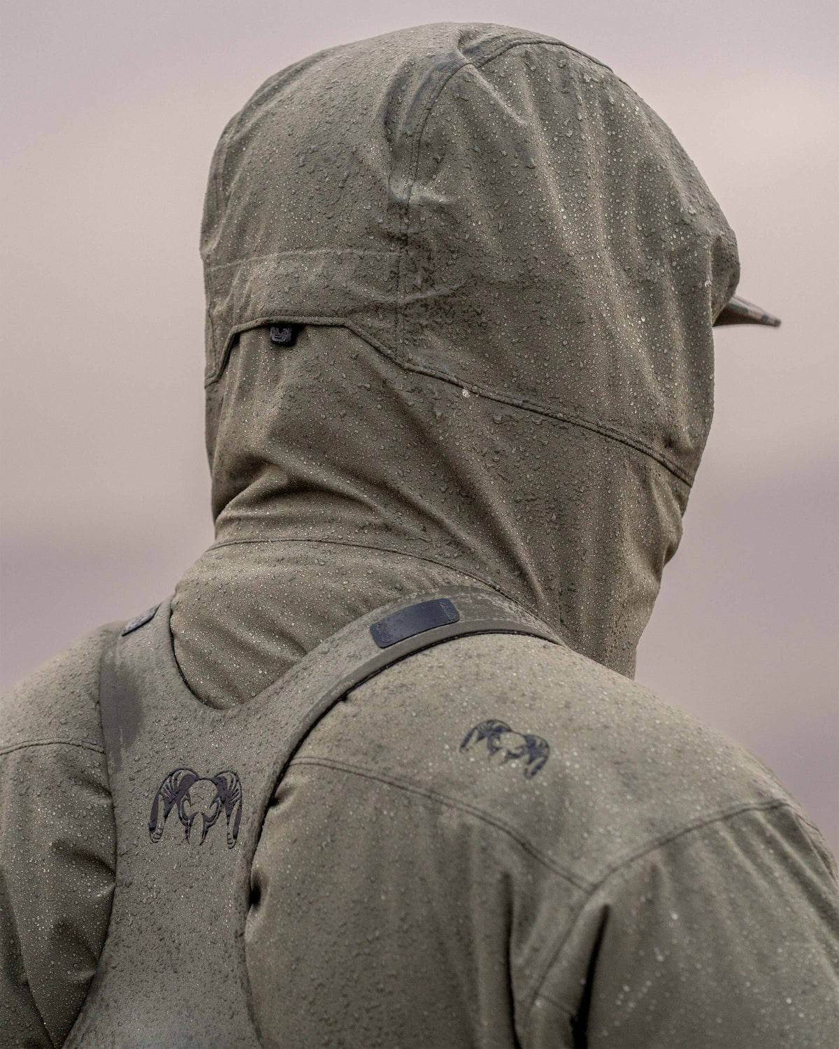 Back view of hunter wearing Mountain PRO Hooded Jacket in Ash Brown, highlighting adjustable hood cinch