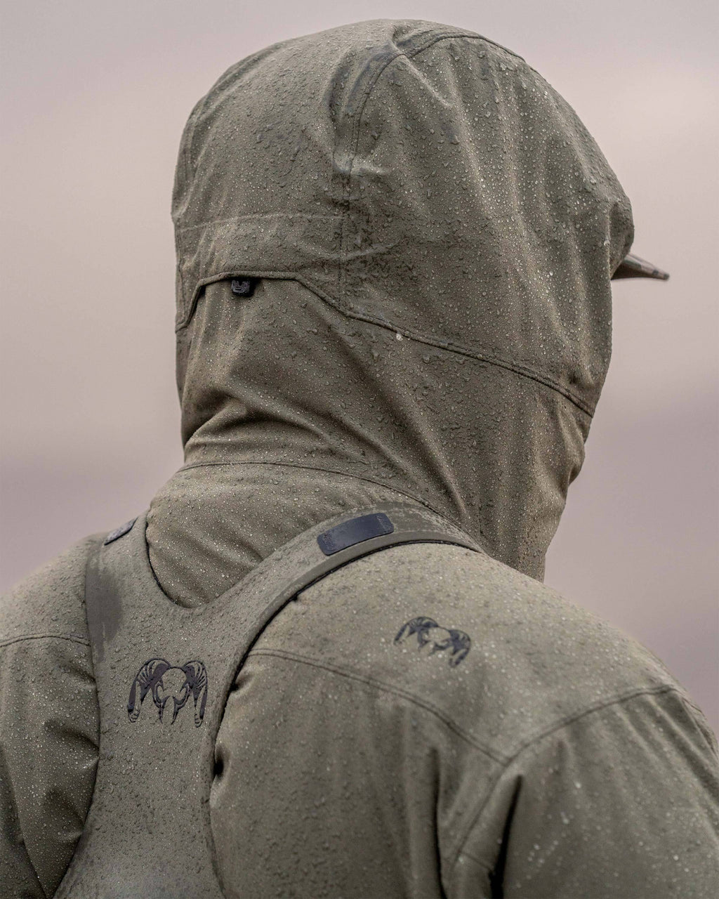 Back view of hunter wearing Mountain PRO Hooded Jacket in Ash Brown, highlighting adjustable hood cinch
