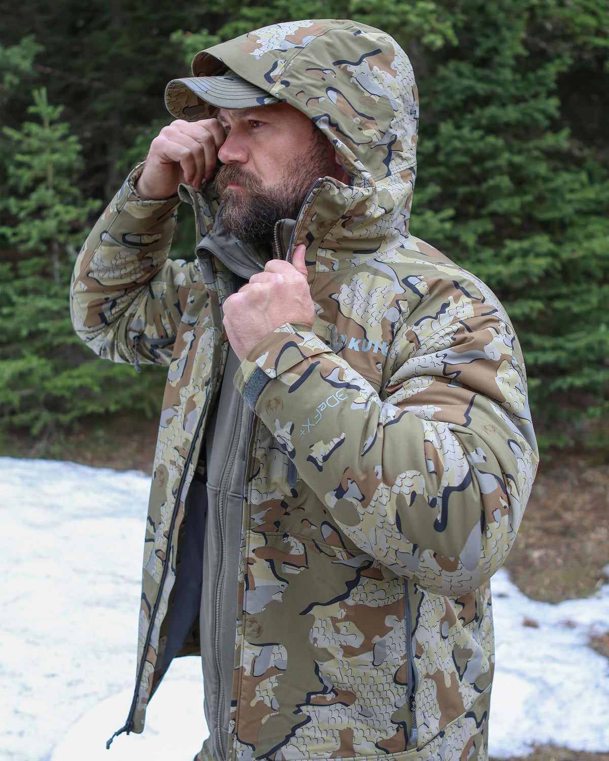Side profile of hunter wearing Mountain PRO Hooded Jacket in Valo Camouflage