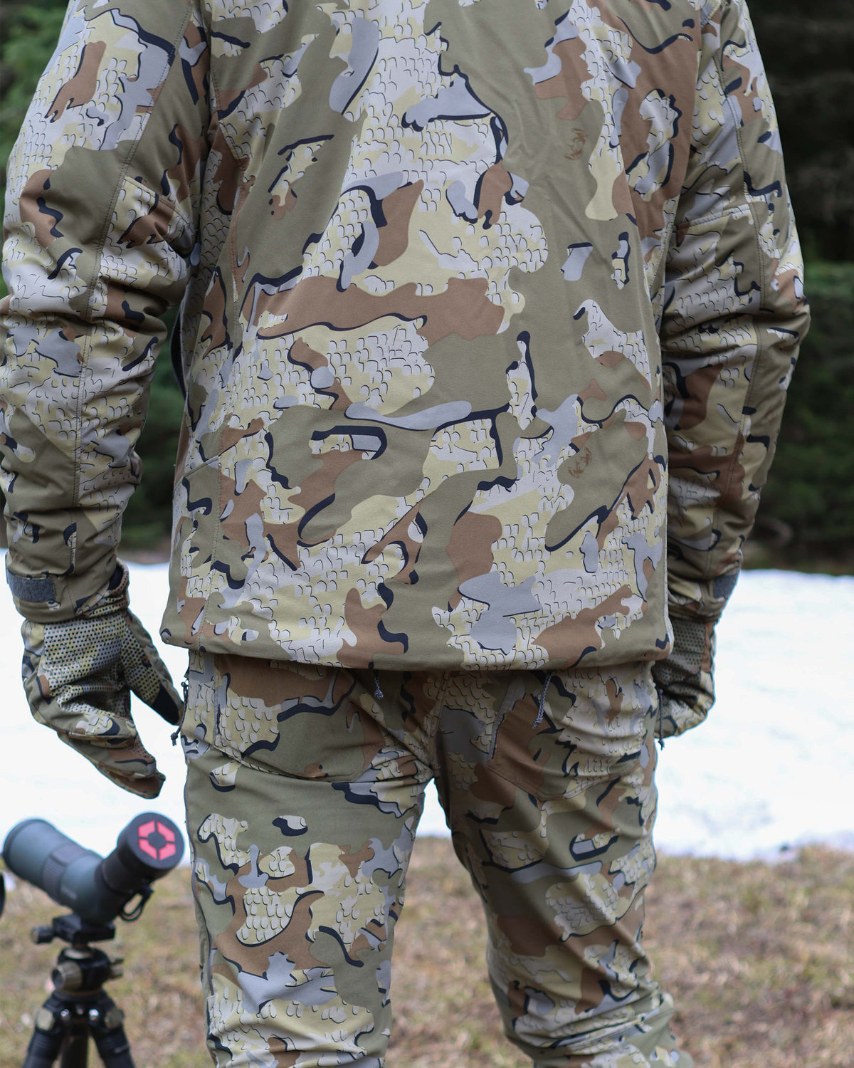 Back view of hunter wearing Mountain PRO Hooded Jacket in Valo Camouflage, Showing the jacket's fit and length