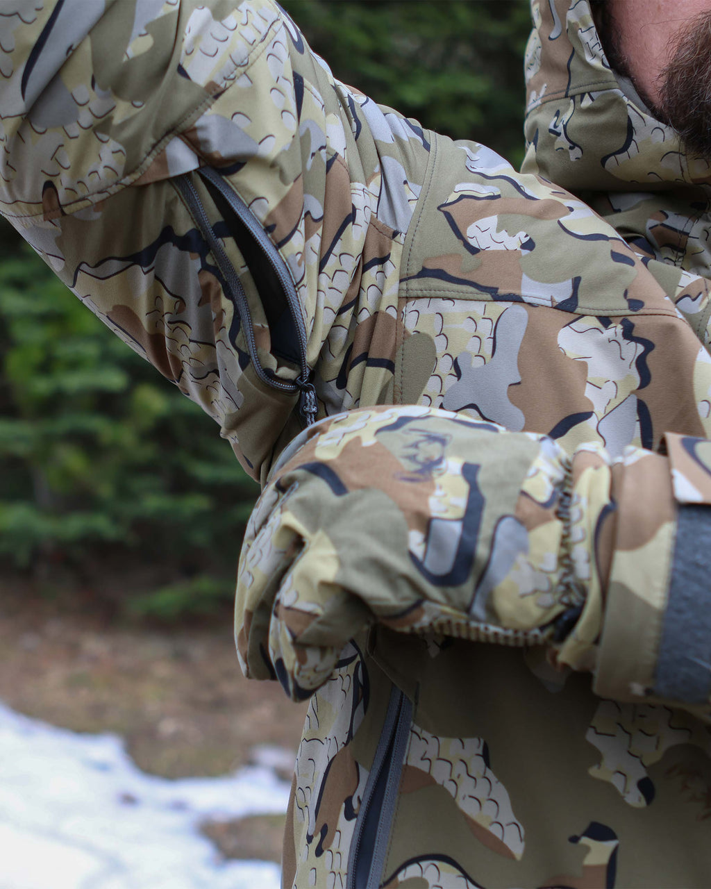 Hunter displaying pit zip ventilation for airflow on Mountain PRO Hooded Jacket in Valo Camouflage