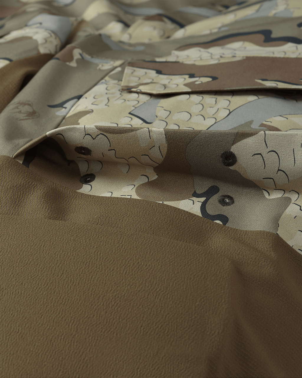 Detail of Billowed thigh pocket with drain holes and secure flap closure on KUIU Paragon Storm Shell Parka in Valo Camouflage