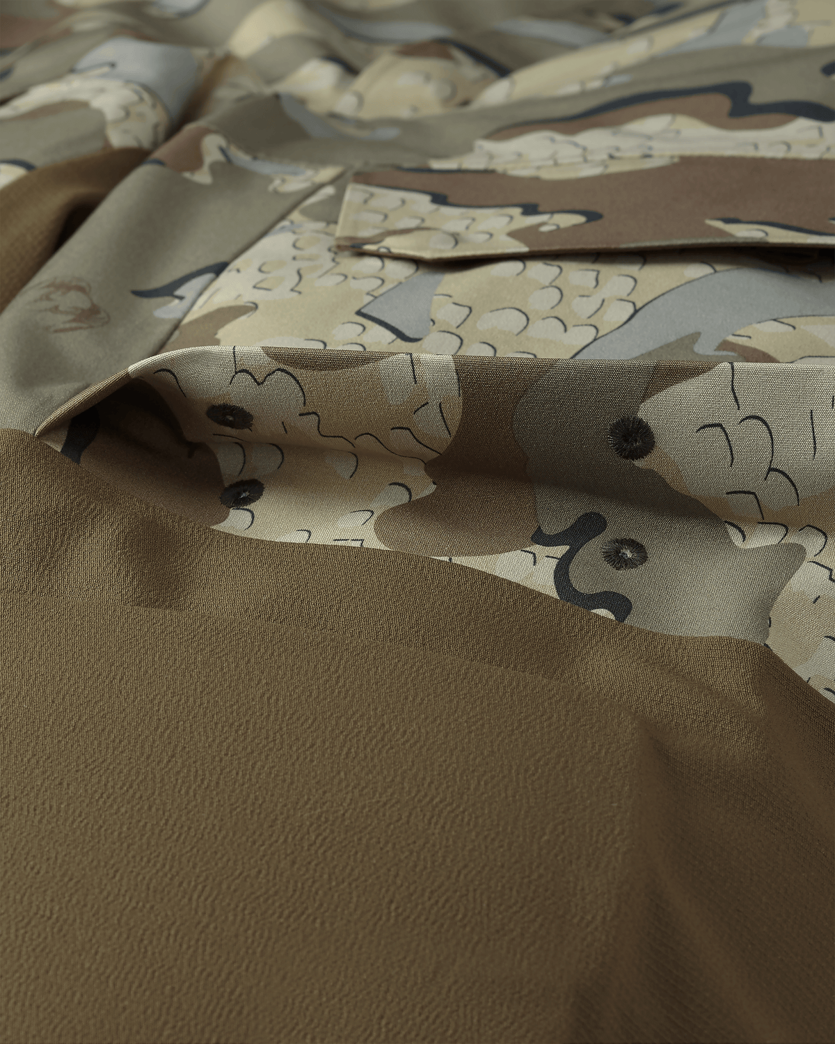 Detail of Billowed thigh pocket with drain holes and secure flap closure on KUIU Paragon Storm Shell Parka in Valo Camouflage