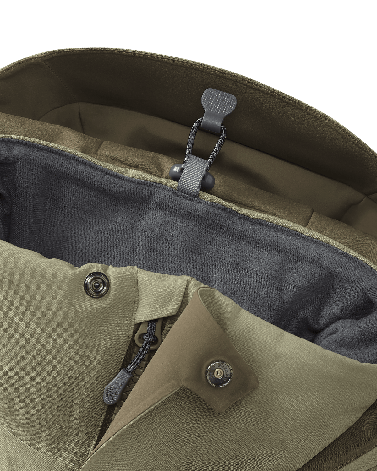 Stowed drop-away hood keeper on the KUIU Paragon Storm Shell Parka in Arctic Shadow Khaki