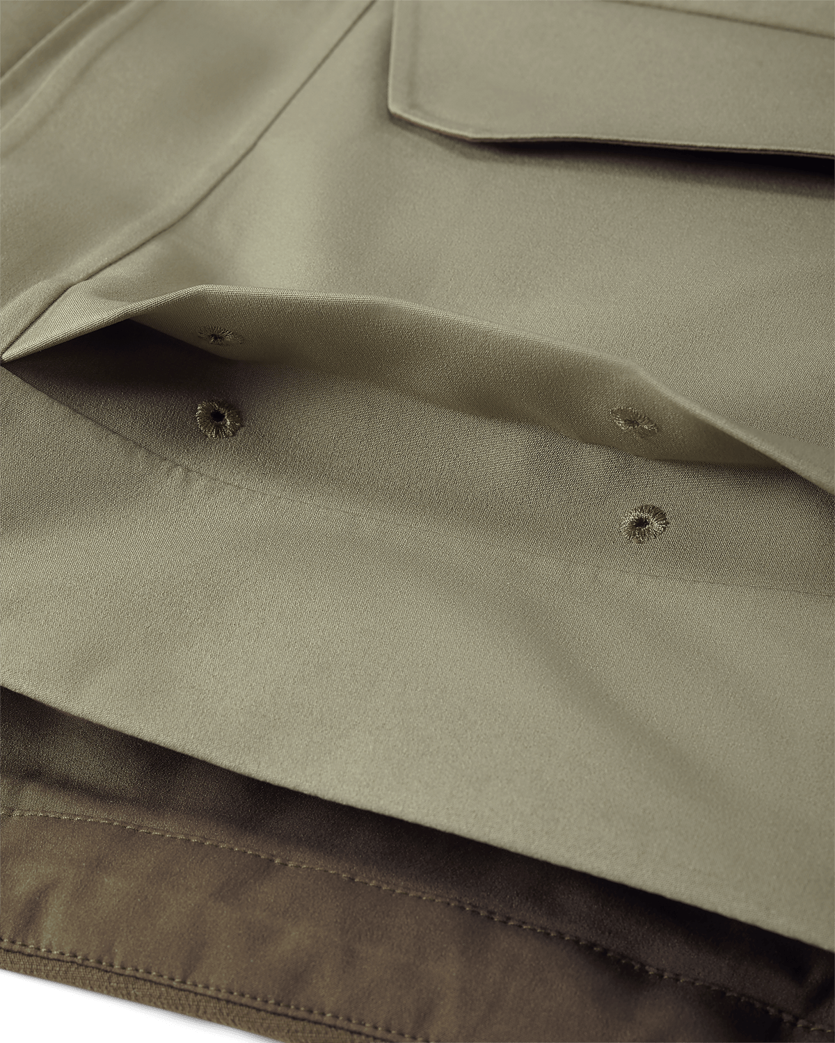 Detail of Billowed shell pocket with drain holes and secure flap closure on KUIU Paragon Storm Shell Parka in Arctic Shadow Khaki