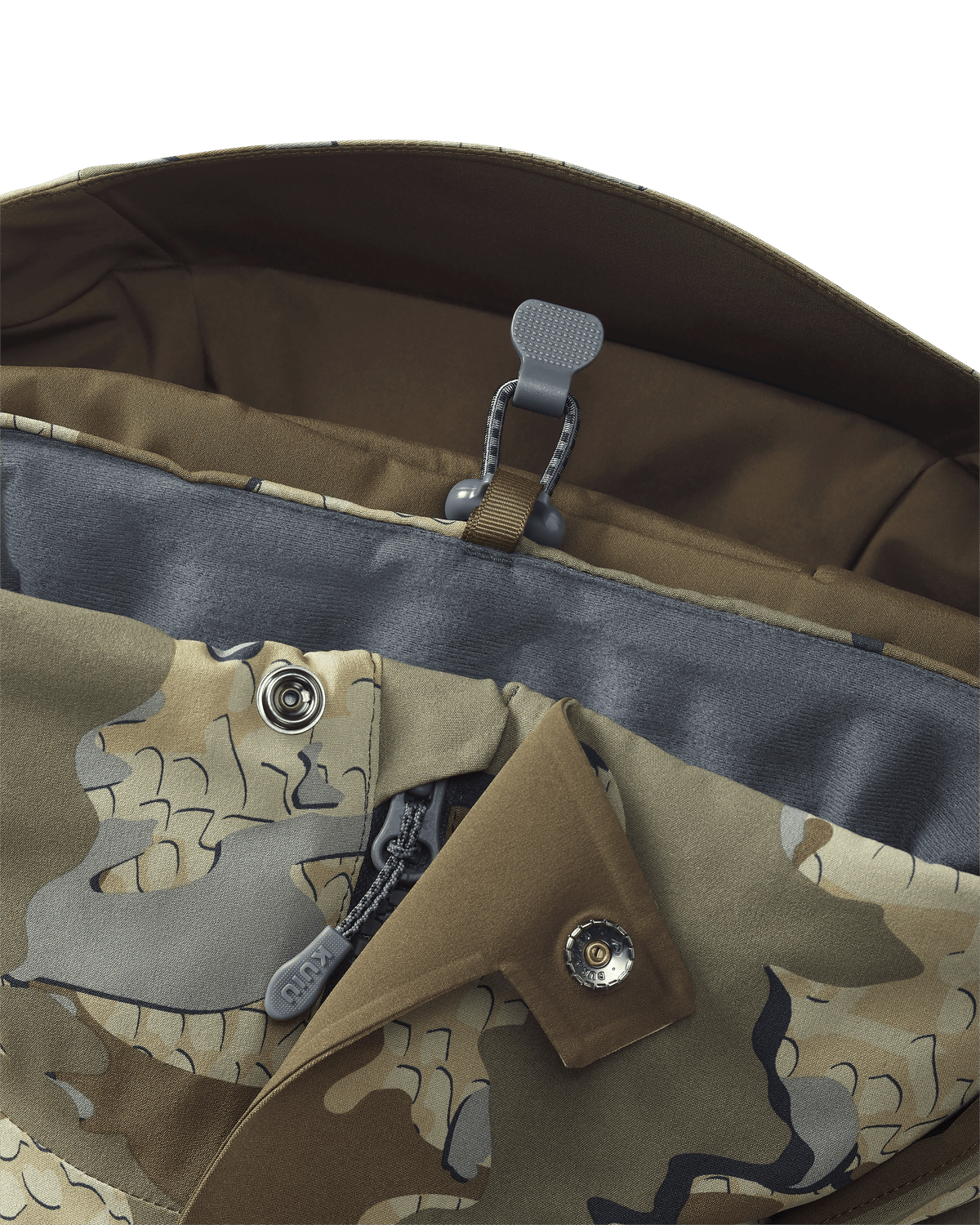 Stowed drop-away hood keeper on the KUIU Paragon Storm Shell Parka in Valo Camouflage