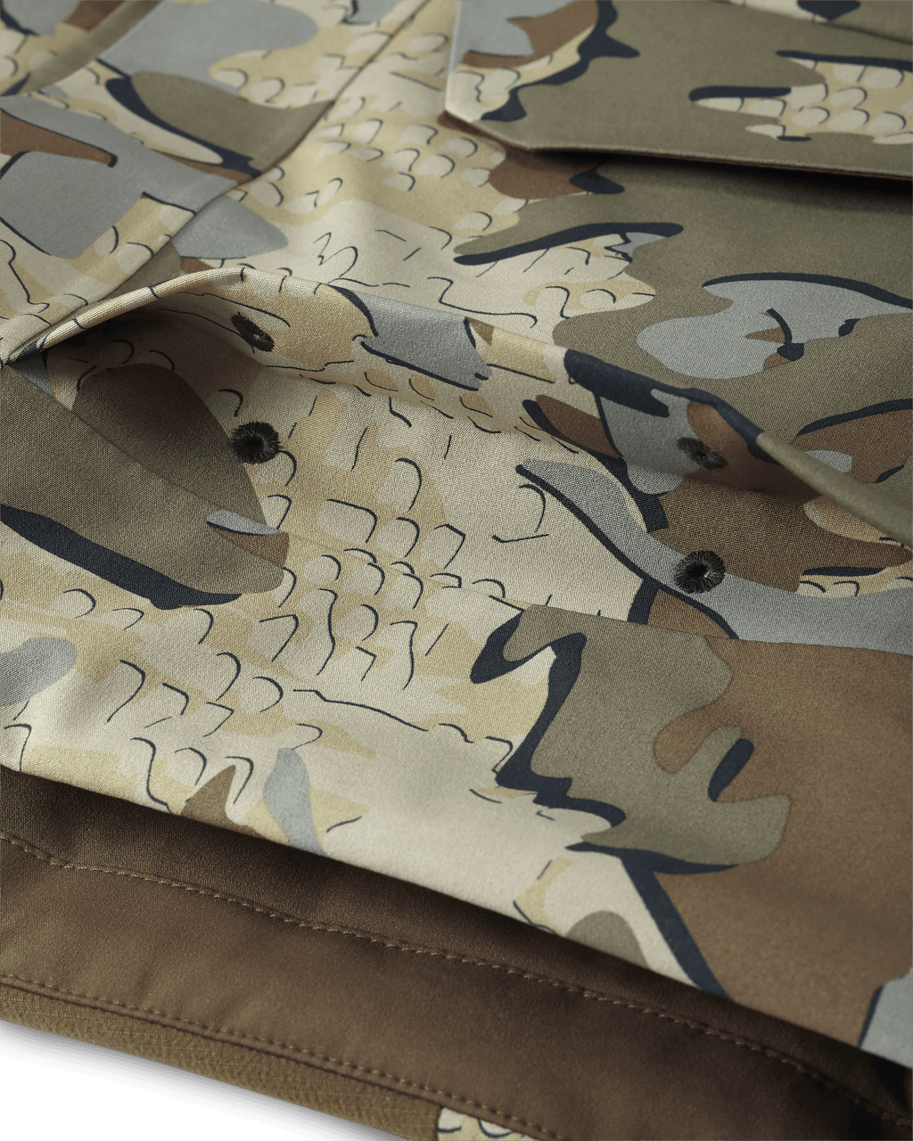 Detail of Billowed shell pocket with drain holes and secure flap closure on KUIU Paragon Storm Shell Parka in Arctic Shadow Valo Camouflage