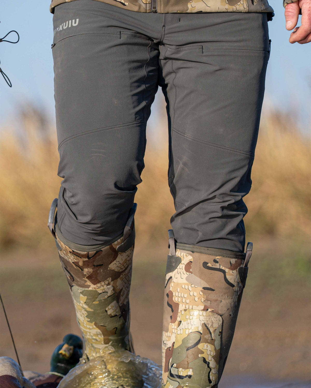 Front, close-up of Reed Pant in Gunmetal Grey, Highligthing pre-curved knee design and hidden zipper thigh pockets