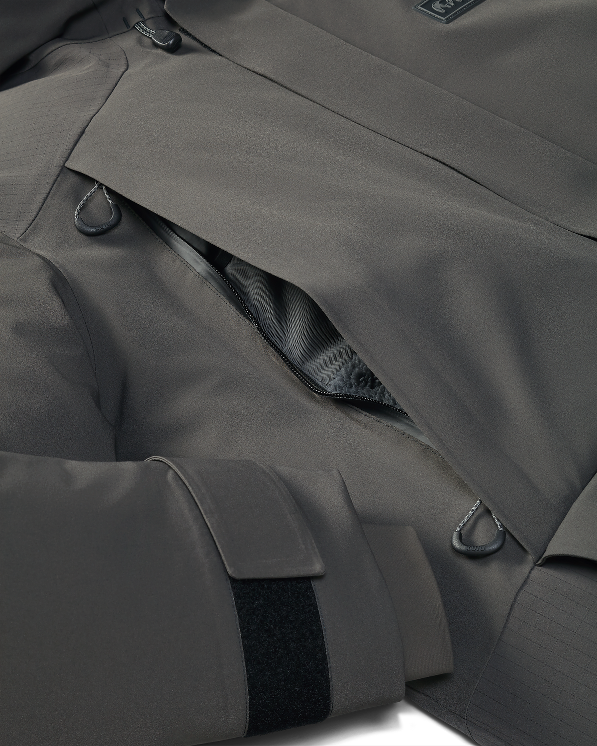 Front of Super Down Arktuk Parka in Asphalt Grey, Highlighting zippered hand pocket and adjustable velcro cuff closure