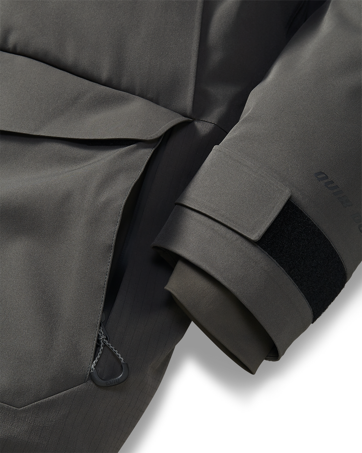 Front of Super Down Arktuk Parka in Asphalt Grey, Highlighting zippered hand pocket and adjustable hook-and-loop cuffs with internal stretch gasket cuffs 