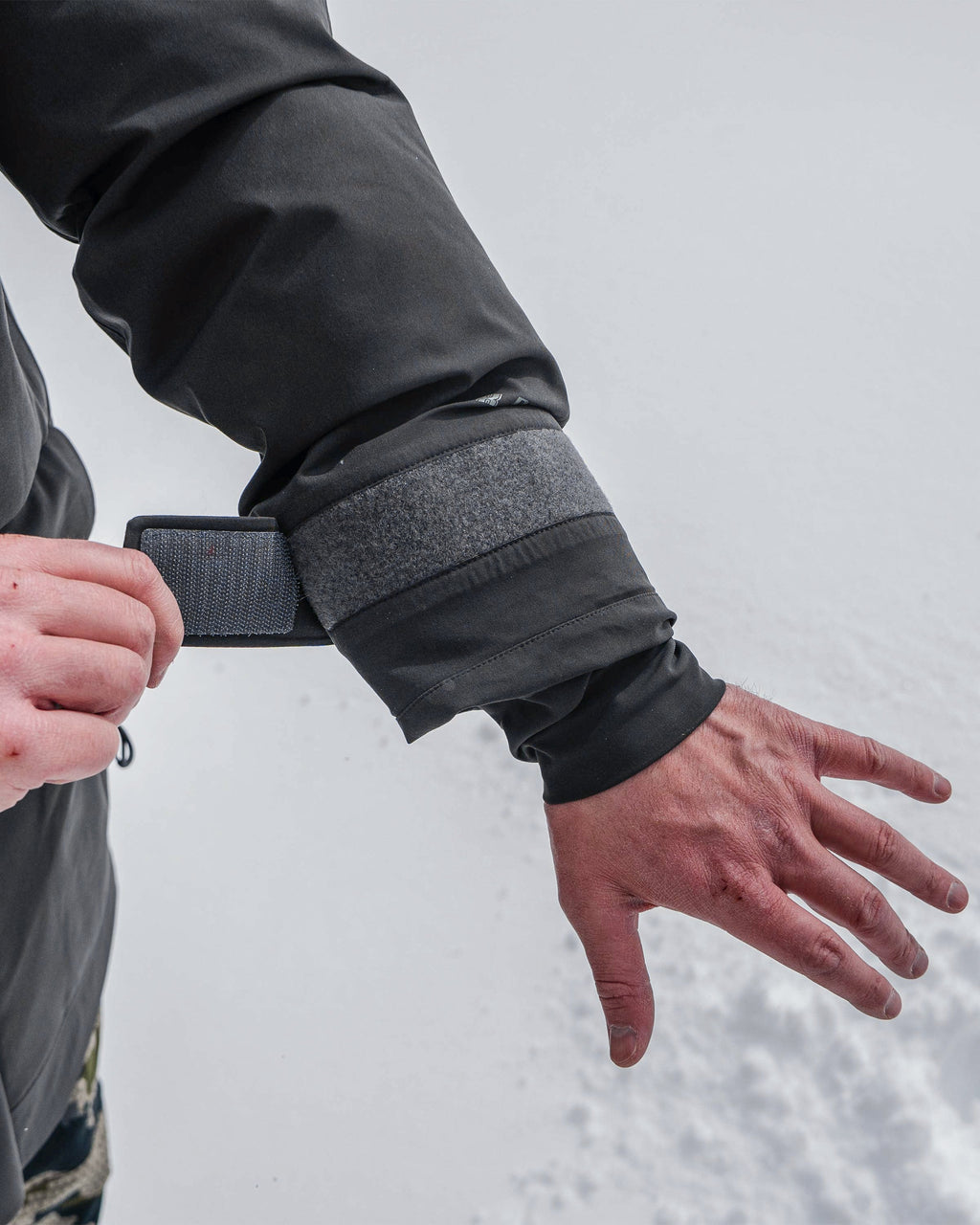Close-up view of hunter displaying hook-and-loop cuffs with internal stretch gasket cuffs for a secure fit