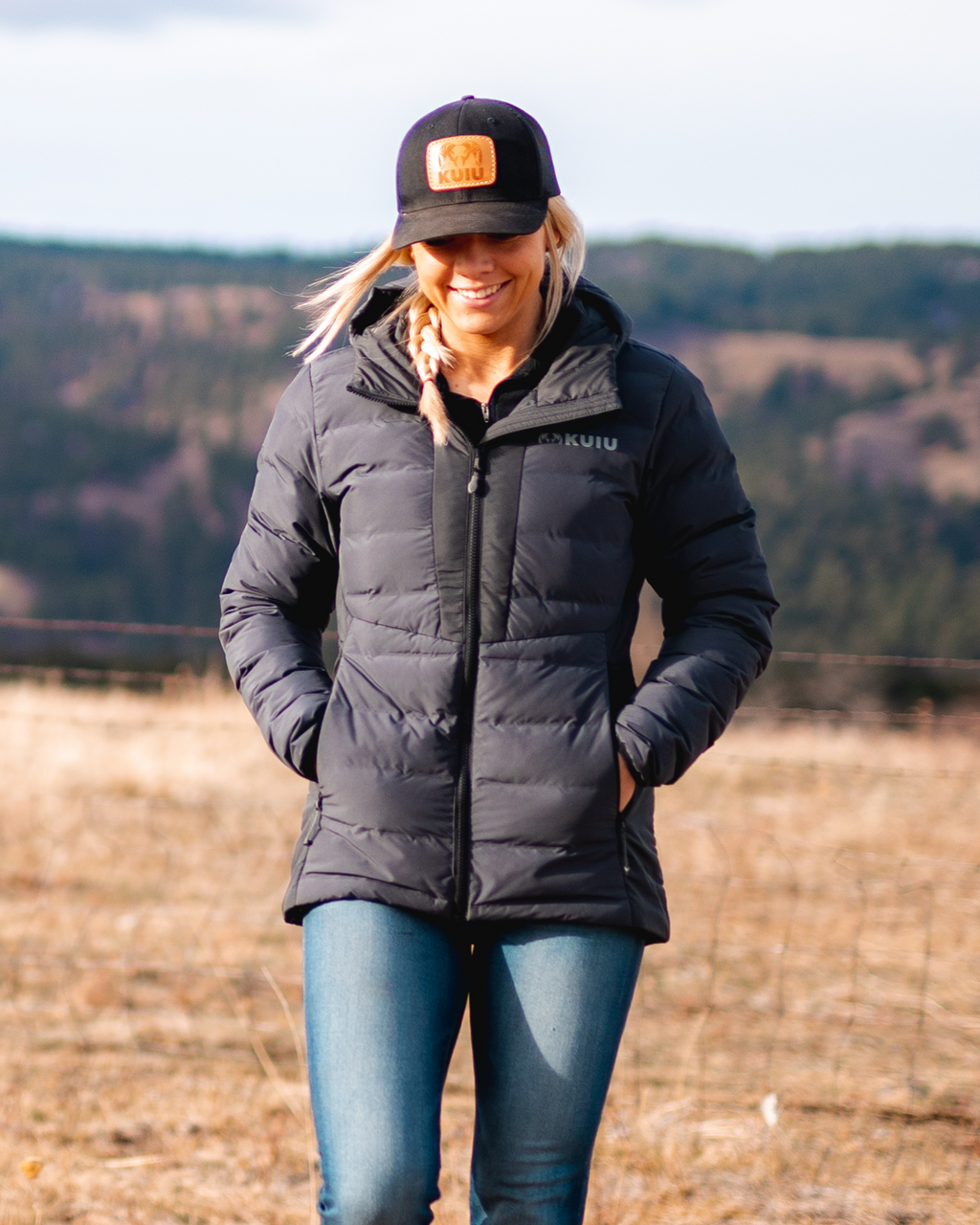 Woman wearing Elements Hooded Jacket in Gunmetal with hands inside zippered hand pockets